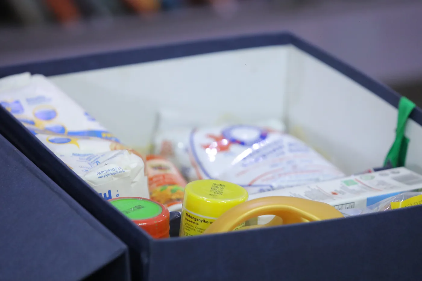 Open gift hamper containing assorted everyday products