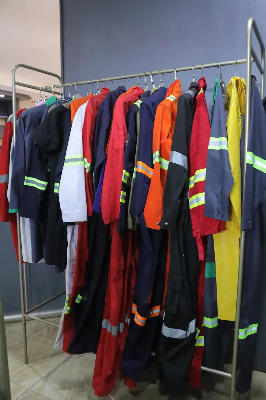 Colourful reflective overalls hanging on a clothing rack